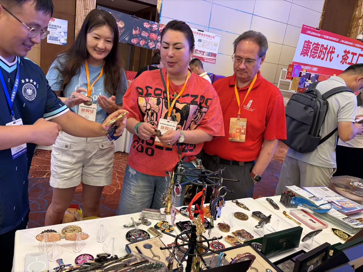 International visitors reviewing custom metal gifts at the GT Gifts booth