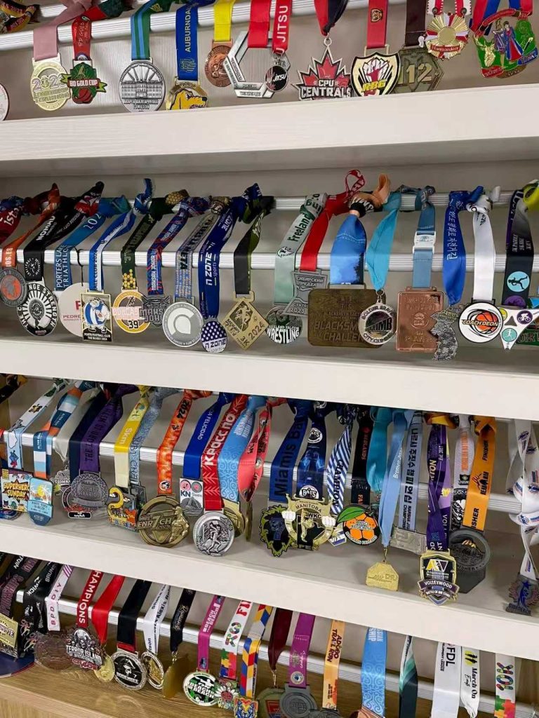 Display of event medals with colorful ribbons for sports and community awards